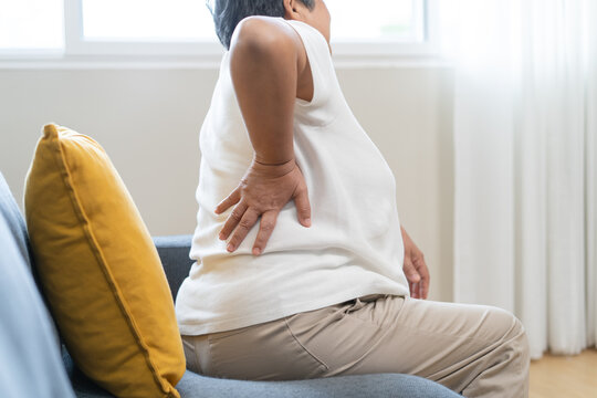 Older woman feeling back pain at home