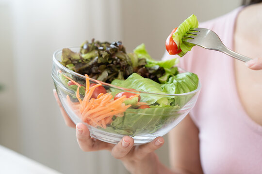 Happy wellness meal, Woman eats salad as lunch and controls calories for the meal for her body care