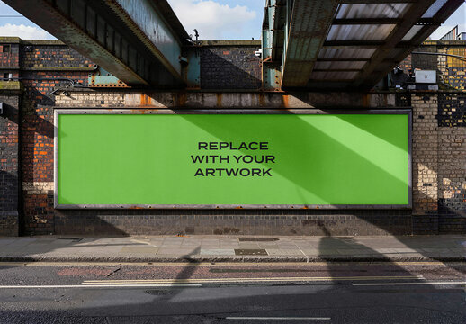 Large horizontal billboard mockup mounted on a brick wall under railway bridge, realistic outdoor advertising display with natural sunlight and shadows, urban street environment