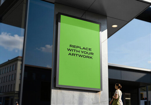 Vertical poster mockup in black frame mounted on exterior wall of modern building, realistic outdoor advertising display with placeholder background