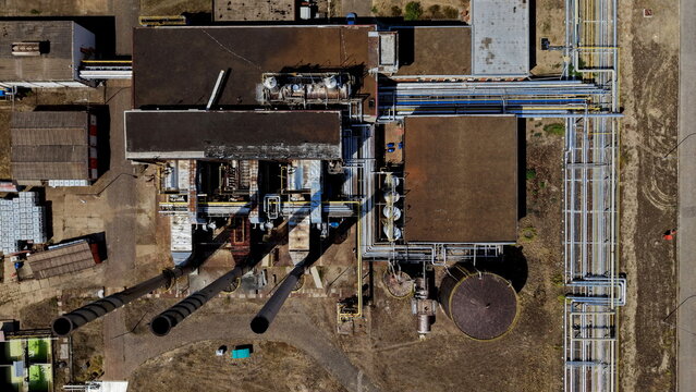Aerial view of the petrochemical industry facility featuring complex pipe networks, tall chimneys, and storage tanks in Pancevo, Serbia.