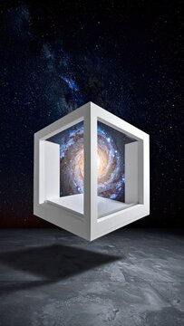 Floating white cube frame containing a spiral galaxy.