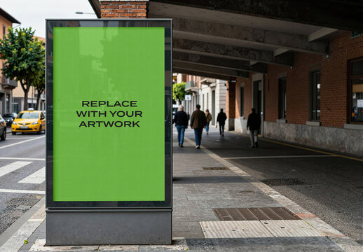 Vertical billboard mockup with placeholder screen displayed on a city sidewalk, realistic urban advertising presentation featuring pedestrians, street, building facade, brick wall