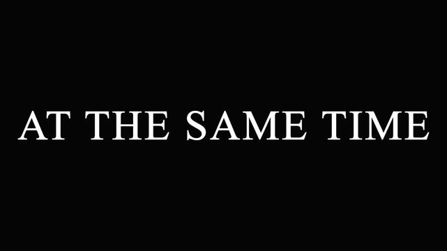 Text AT THE SAME TIME repeating across screen in cinematic motion with subtle color shifts