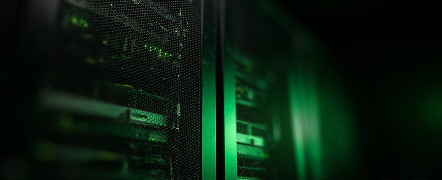 Close-up view of a server with digital data streaming on a dark background, illuminated in shades of green, conveying technology and network connectivity.
