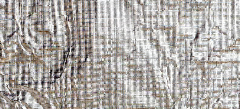 Wrinkled silver foil reflecting light and textured surface