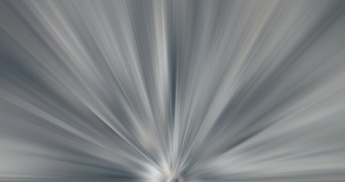Abstract grey background with directional motion blur lines bursting from the bottom center