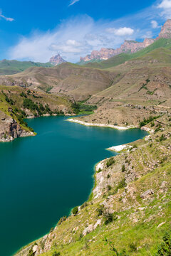 Scenery of turquoise Lake Gizhgit in Caucasus mountains in summer, Russia