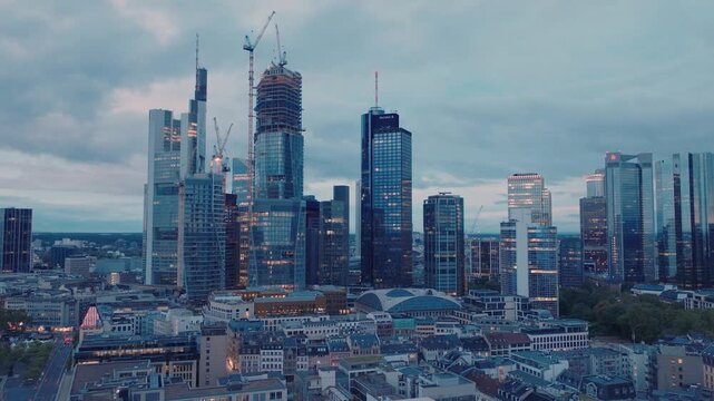 Aerial view of the modern Frankfurt skyline featuring skyscrapers and construction cranes in Frankfurt am Main, Hessen, Germany.