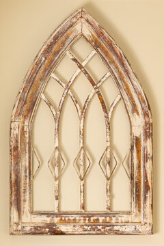 Distressed, Gothic-arched wooden and metal church window frame from circa early 1900, with weathered white, red, and brown finish.