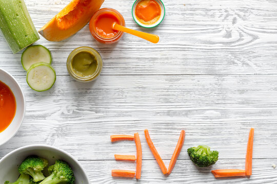 baby vegetable puree on wooden background top view