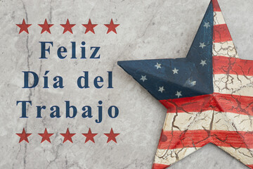 Fototapeta premium Feliz Día del Trabajo text with retro USA red and blue star on stone for Happy Labor Day