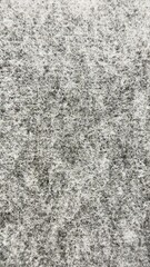 Vertical grey and white felt texture background with rough fiber pattern © Alla
