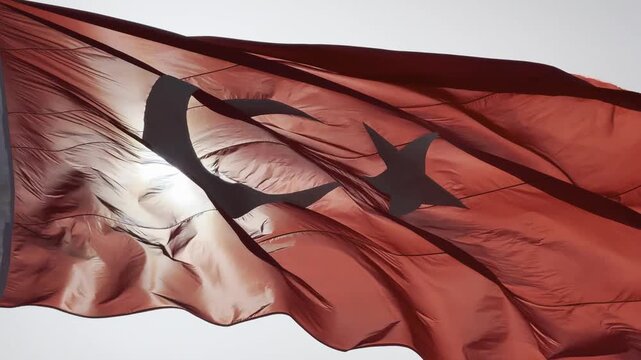 Turkish flag waving proudly in the wind against a clear blue sky, capturing the majestic details of the crescent and star in high-quality 4K footage, perfect for national holidays, patriotic themes, a