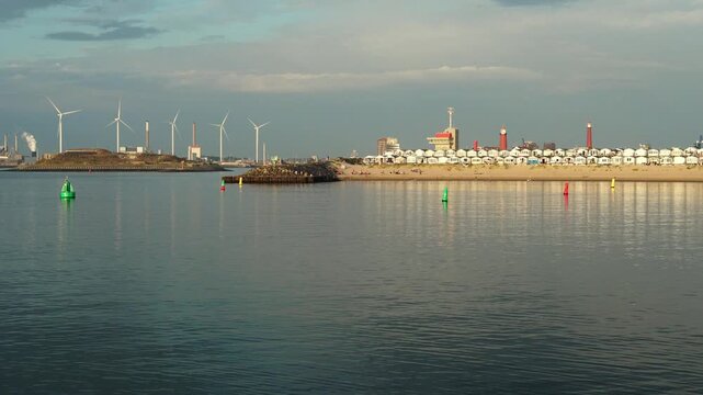 IJmuiden beach and wind turbines across the harbor