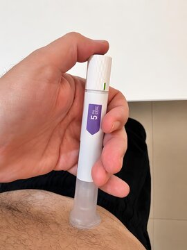 Person Using Injectable Medication Pen on Abdomen for Subcutaneous Treatment and Healthcare