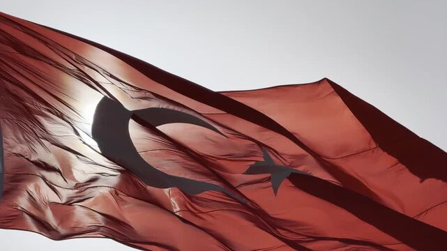 Turkish flag waving proudly in the wind against a clear blue sky, capturing the majestic details of the crescent and star in high-quality 4K footage, perfect for national holidays, patriotic themes, a