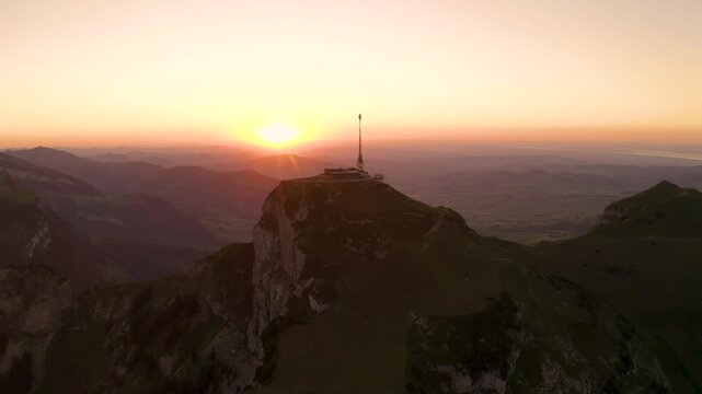 Aerial view of Hoher Kasten peak in the Alpstein massif at sunset, featuring the mountain restaurant and telecommunications tower, Appenzell, Appenzell Innerrhoden, Switzerland.