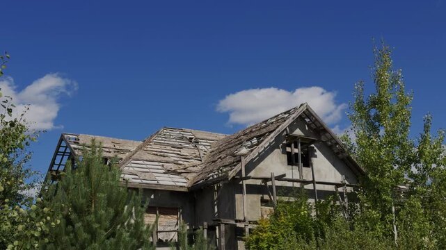 Abandoned decaying house with a ruined roof