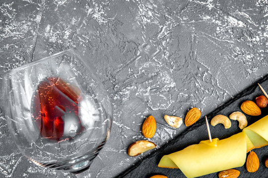 red wine with cheese on dark background top view