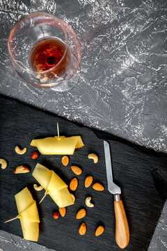 red wine with cheese on dark background top view