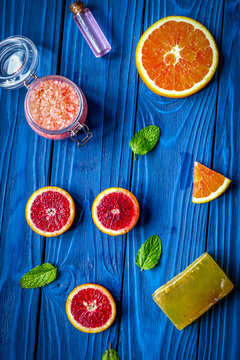 organic cosmetic with citrus on blue background top view