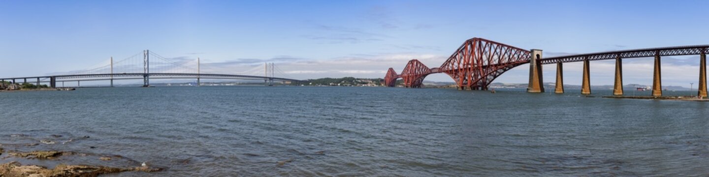 Panoramic view of the Forth Bridge, a historic railway bridge across the Firth of Forth and UNESCO World Heritage Site, and the Forth Road Bridge, in South Queensferry, Scotland.