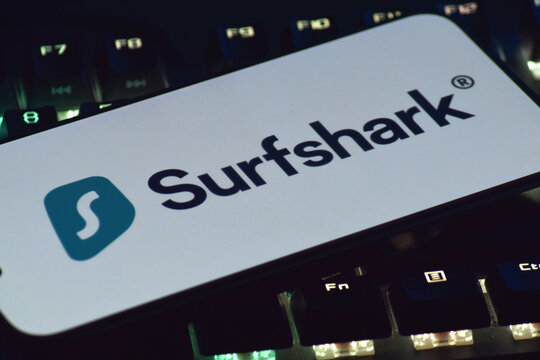 On a mobile phone screen logo Surfshark Corp global computer security software company.