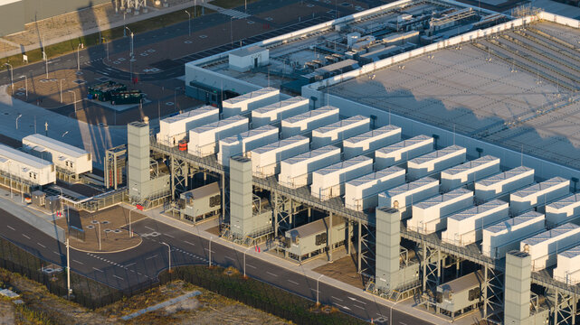 Aerial view of the Google data center facility featuring rows of white cooling units and industrial infrastructure on a paved site in Eemshaven, Groningen, Netherlands.