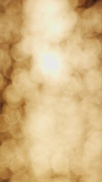 Vertical video. Golden Sunset Bokeh in Soft Focus Creating Warm Abstract Light Reflection Across Calm Sea Surface, Dreamy Evening Atmosphere, Tranquility, Relaxation