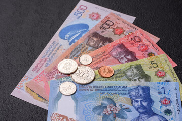 Brunei paper money, dollar banknotes and sen coins as currency for exchange or travel. Brunei money © chernikovatv
