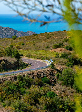 Mediterranean sea coast road into mountains horizon in summer with beautiful bright sun rays