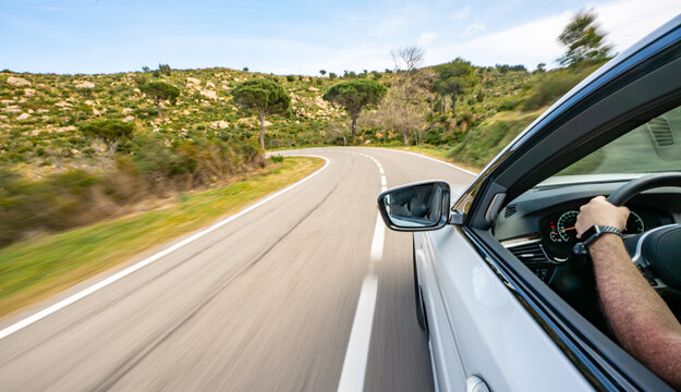 Mediterranean sea coast road into mountains horizon in summer with beautiful bright sun rays