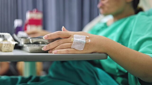 Patient receiving intravenous fluid therapy in hospital ward