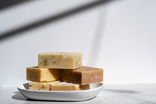 Handmade Artisan Soap Bars Stacked on White Ceramic Plate