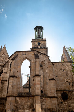 Hanover, Germany - July 1, 2026: Ruins of the Aegidienkirche war memorial rise beneath the surviving bell tower in Hanover city centre.