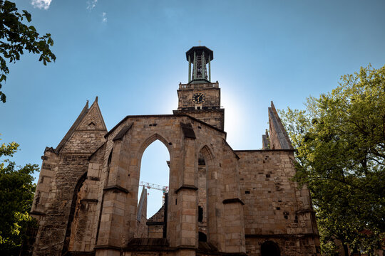 Hanover, Germany - July 1, 2026: Ruins of the Aegidienkirche war memorial rise beneath the surviving bell tower in Hanover city centre.