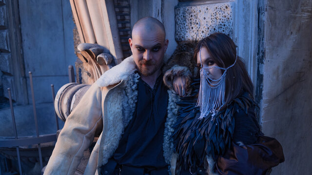 Man and woman in dark leather and sheepskin coats, rock band promo style photo