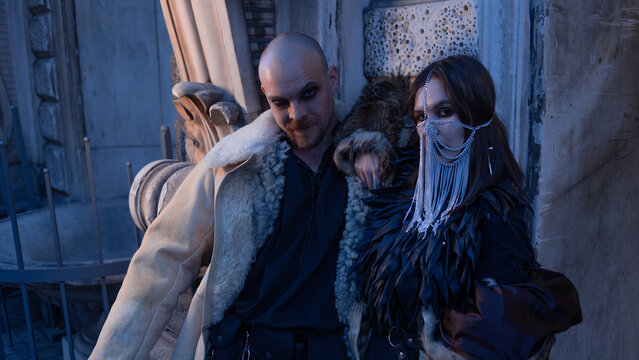 Alternative couple in fur coats and leather outfits, gothic subculture, street portrait