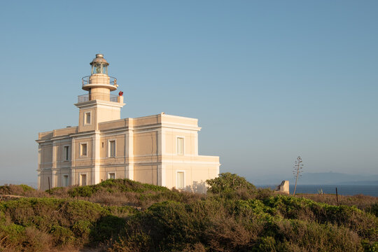 Lighthouse, panorama of the San Giovanni in Sinis promontory, sea view at sunset, in the municipality of Cabras, Italy.