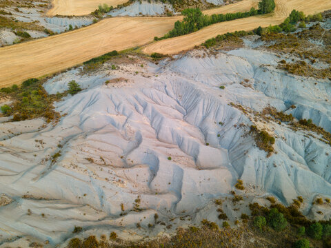Aerial view of the pale eroded clay hills and gullies of the badlands in the Spanish Pyrenees foothills near Jaca Aragon Spain an abstract natural pattern sculpted by water and time.