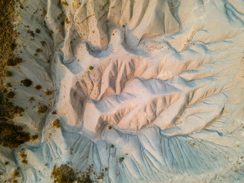 Aerial view of the eroded clay badlands with their intricate gullies in the dry foothills near Jaca in Aragon Spain an abstract natural texture carved by centuries of erosion.
