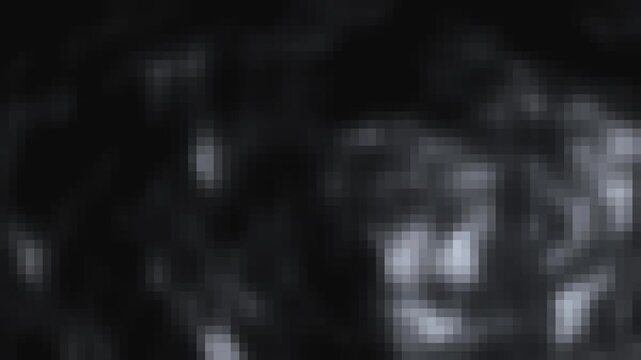 Abstract dark background with soft pixelated motion blur and subtle light particles