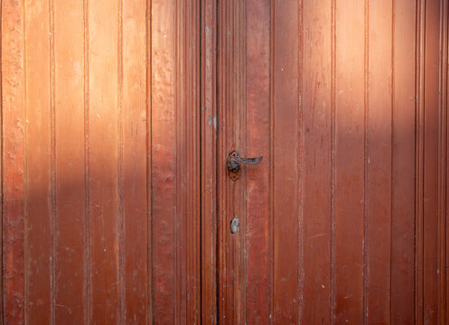 Rustic wooden door with aged texture and faded paint