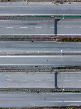 Aerial view of a multi-lane highway with clear road markings, asphalt surface, and concrete dividers in Coimbra, Coimbra, Portugal.