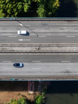 Aerial view of Ponte Rainha Santa Isabel spanning the Mondego River with vehicles driving on the asphalt road in Coimbra, Coimbra, Portugal.