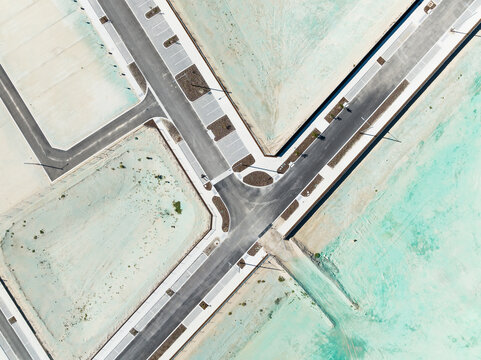 Aerial view of Ocean Reef Boat Harbour showing a road intersection with paved streets and surrounding sandy coastal land in Ocean Reef, Western Australia, Australia.