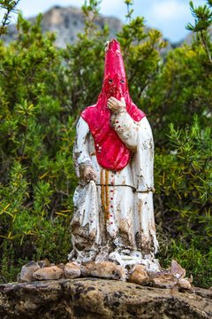 Nazareno statue with capirote hood on mountainside