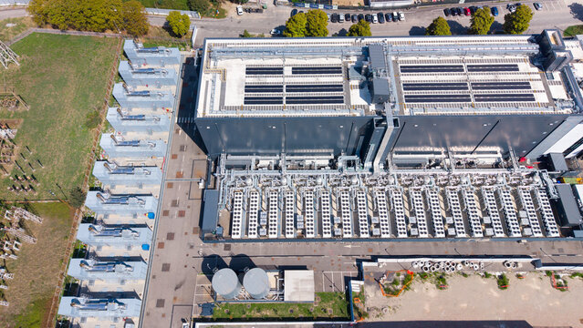 Aerial view of the Equinix Data Center featuring rows of industrial cooling units, rooftop solar panels, and complex infrastructure in Castelletto, Lombardia, Italy.