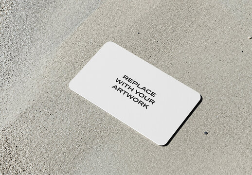 Business card mockup with rounded corners placed on a textured concrete surface, realistic stationery branding presentation, template for graphic design and print media
